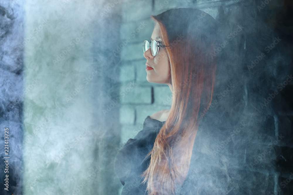 portrait of a woman in a smoke, eyes in glasses / business concept, beautiful woman, sexy business girl. Stress, smoking, relaxed.