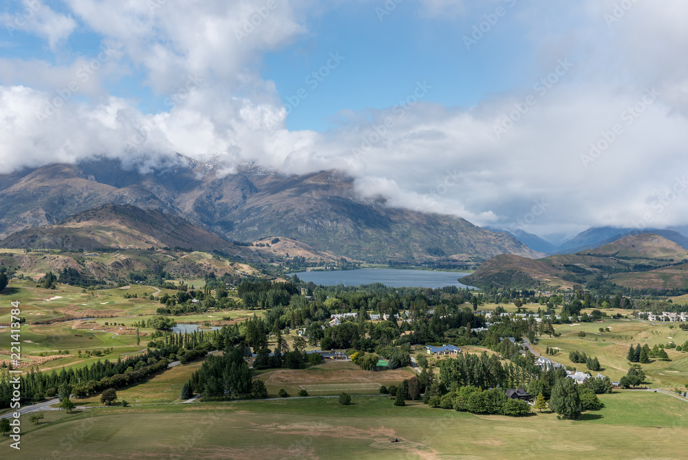 Lake Hayes with the Remarkables mountain range in the background, viewed from the top of Feehly Hill, Arrowtown, New Zealand.
