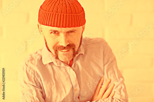 guy with a mustache in a red knitted hat photo