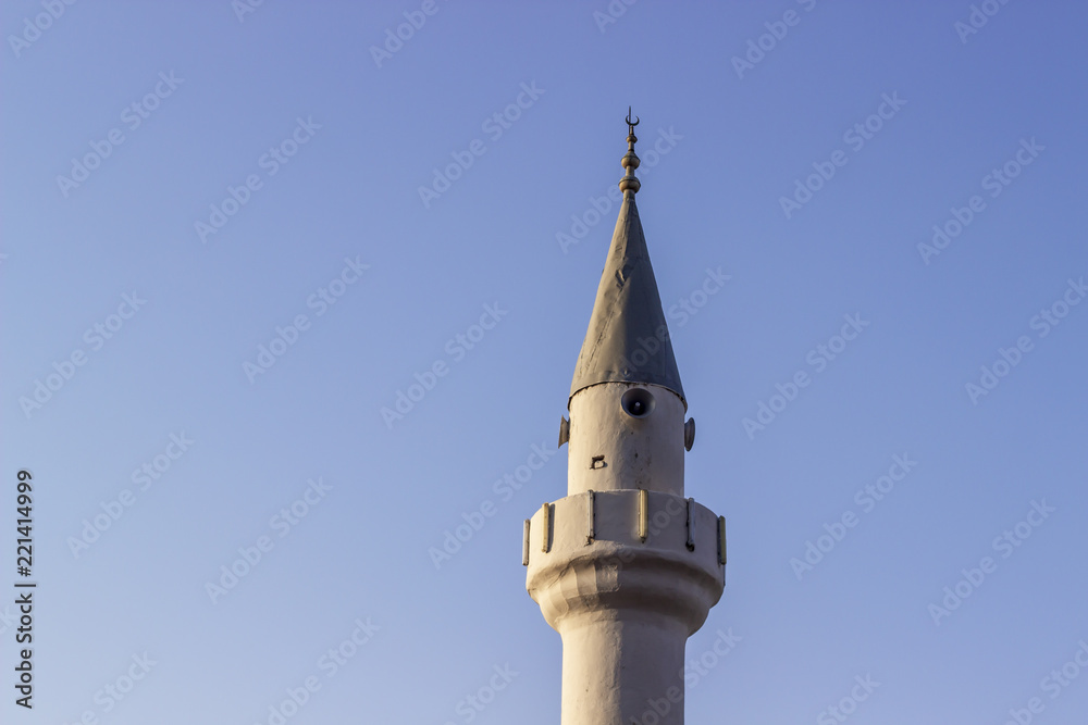 Clear shoot of old masonry minaret with blue sky background Clear shoot of old masonry minaret with blue sky background
