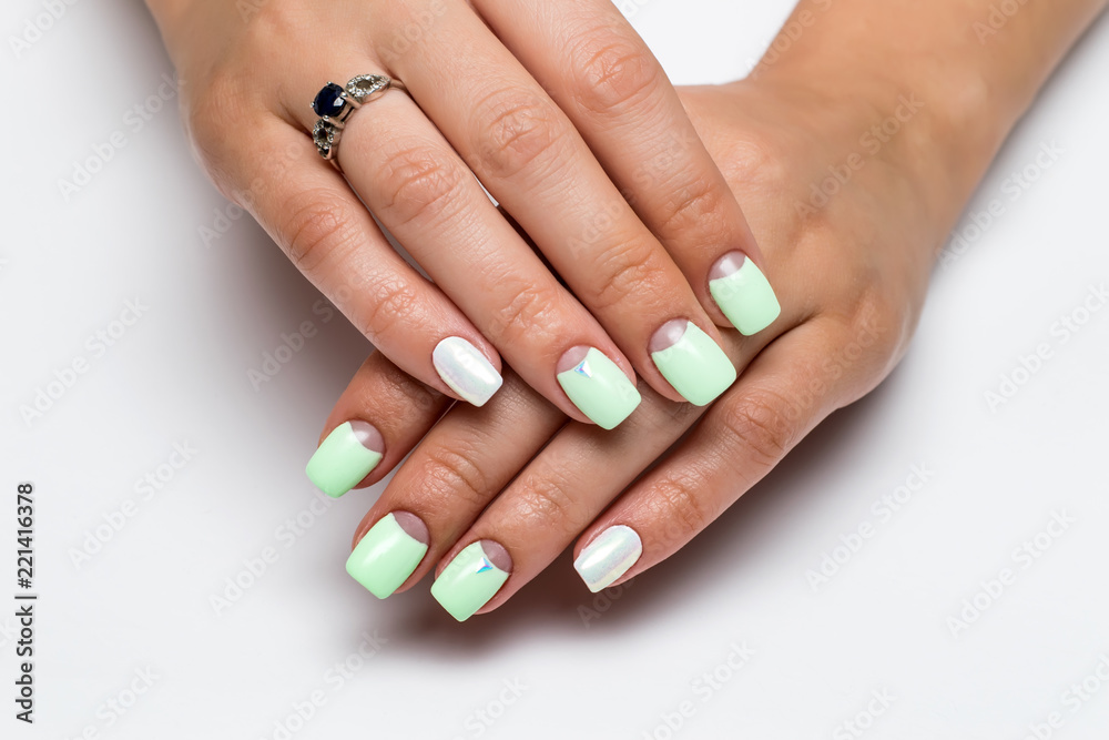 pastel mint moon manicure on square short nails with crystals on nameless fingers on a white background
pastel mint moon manicure on square short nails with crystals on nameless fingers on a white background