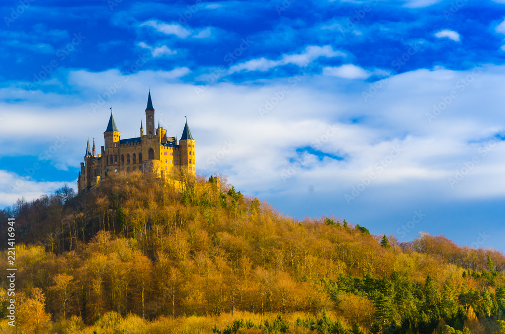 Old historical middle age castle palace for queen king prince and princess on top of mountain under sunset sky