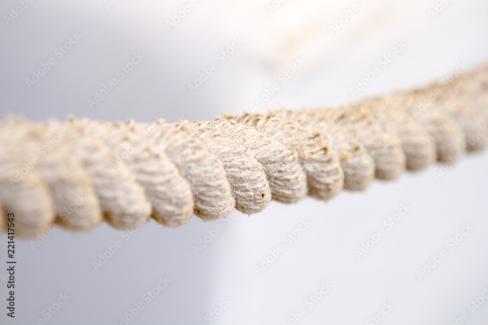 White woven hemp rope with a disheveled texture. The old shabby