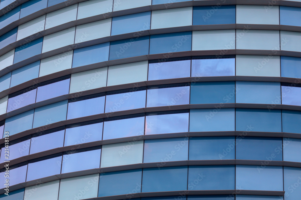 Glass building walls in the rays of sunset as background Glass building walls in the rays of sunset as background
