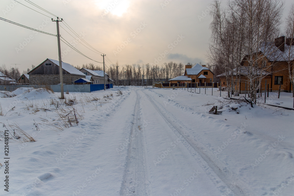 Road in the snow at sunset in winter