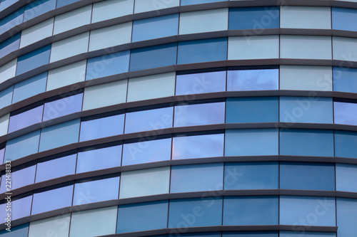 Glass building walls in the rays of sunset as background