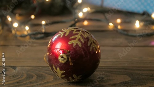 Closeup slow motion video of camera following falling baubble from Christmas tree photo