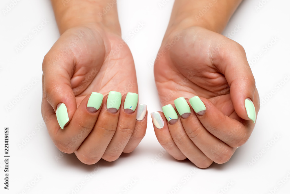 pastel mint moon manicure on square short nails with crystals on nameless fingers on a white background