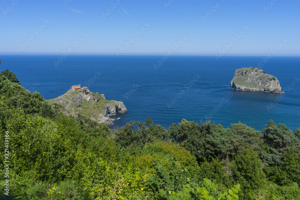 Summer sea, San Juan Gaztelugatxe island view, basque country, historical island with chapel in Northern Spain