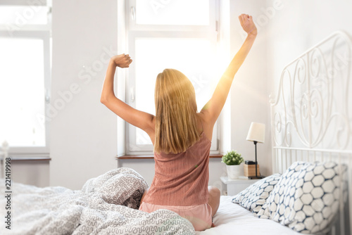 Woman wakes up at sunrise
