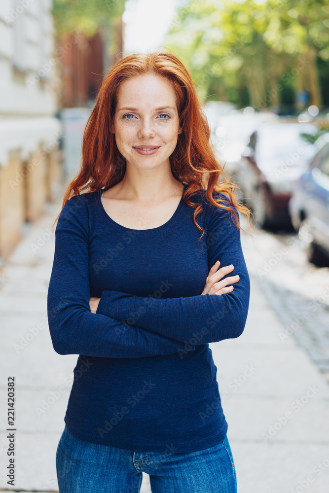 Confident slim young redhead woman