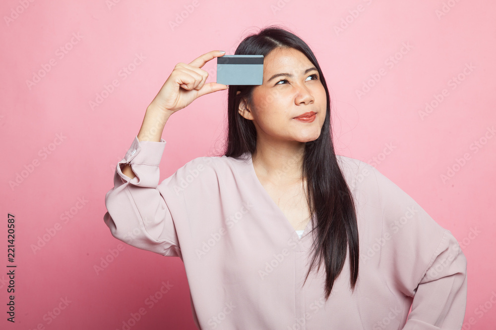 Young Asian woman think with a blank card. Young Asian woman think with a blank card.