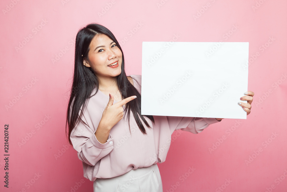 Young Asian woman point to blank sign. Young Asian woman point to blank sign.