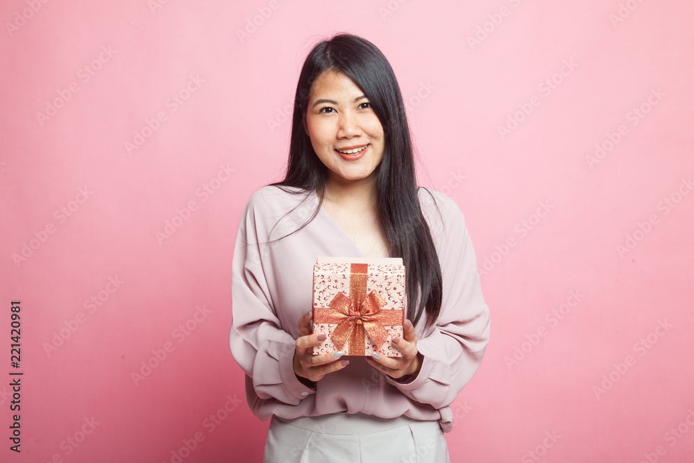 Young Asian woman with a gift box. Young Asian woman with a gift box.