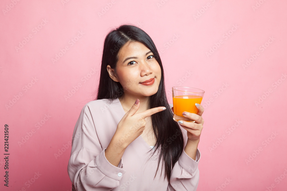 Young Asian woman point to orange juice. Young Asian woman point to orange juice.