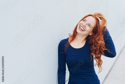 Attractive vivacious young redhead woman