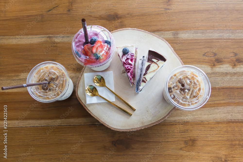 Flatlay,beverage set of iced coffee blueberry cake and smoothie in wood table at cafe Flatlay,beverage set of iced coffee blueberry cake and smoothie in wood table at cafe