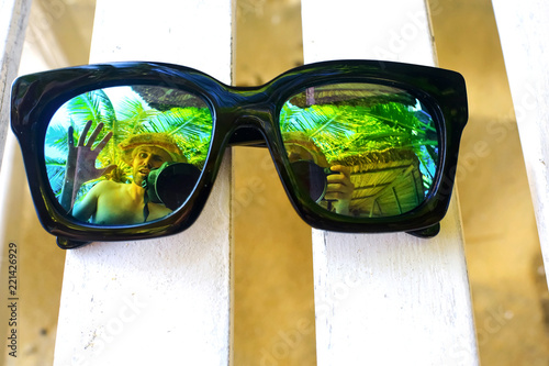 Fototapeta Naklejka Na Ścianę i Meble -  Sun glasses lying on a deckchair