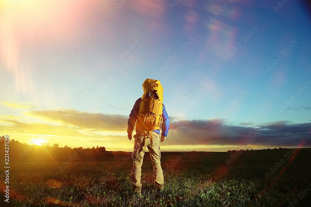 Fototapeta premium traveler man in the field, happy guy, concept freedom leisure nature, landscape beautiful place nature