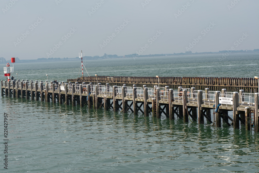 Sea near Vlissingen, Zeeland, Netherlands, old wooden pier at high tide