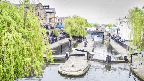 Time lapse view of the canal at Camden Town at the entrance of the famous Camden Lock market in London, Uk. photo