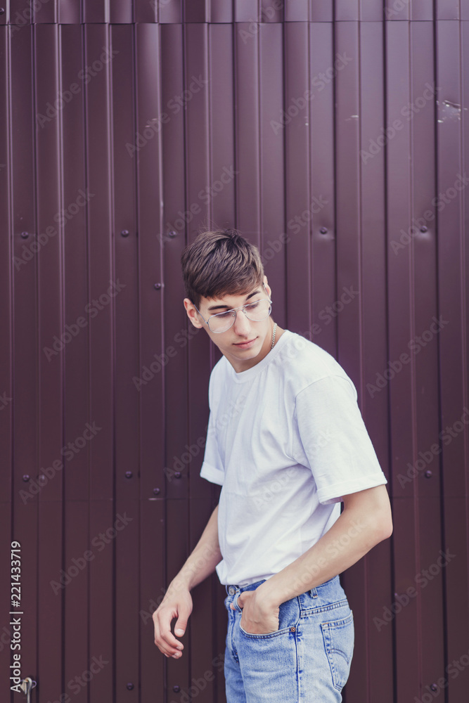 Portrait of young stylish man in the street, lifestyle