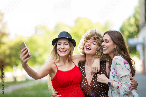 Three friends taking selfies 