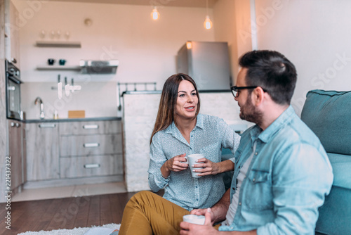 Cute couple talking indoors.