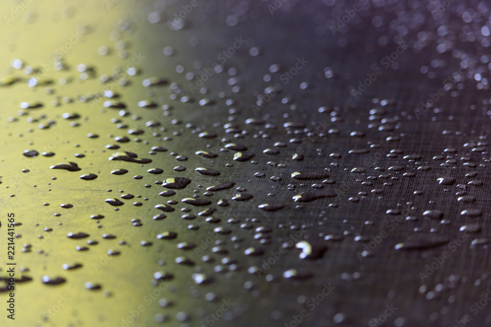 Water droplets on a grey plastic surface. Abstract background