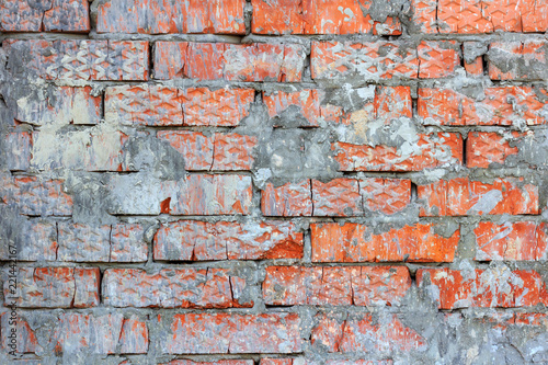 Vintage red brick wall texture closeup with cement mortar stains. Abstract brick wall background