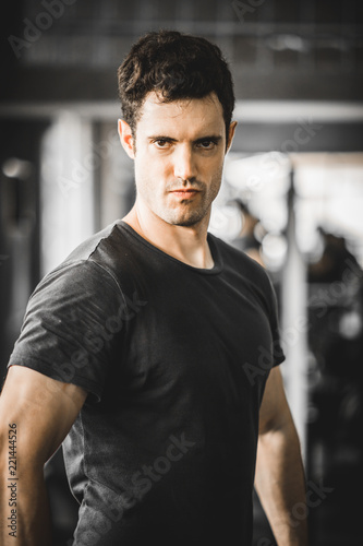 Fit caucasian handsome young man and big muscle in sportswear. Portrait of young man action after exercise class in a gym. Healthy sports lifestyle, Fitness concept. with copy space for your text. © Shutter B