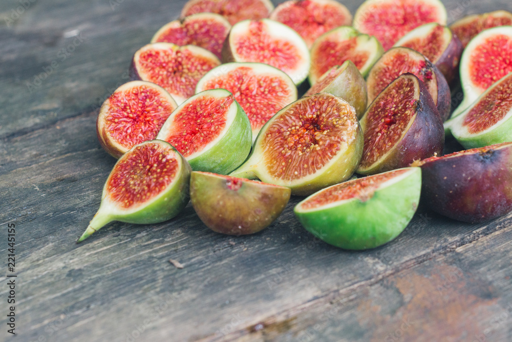 Fresh red figs background on an old wooden table. Top view. Close up Fresh red figs background on an old wooden table. Top view. Close up