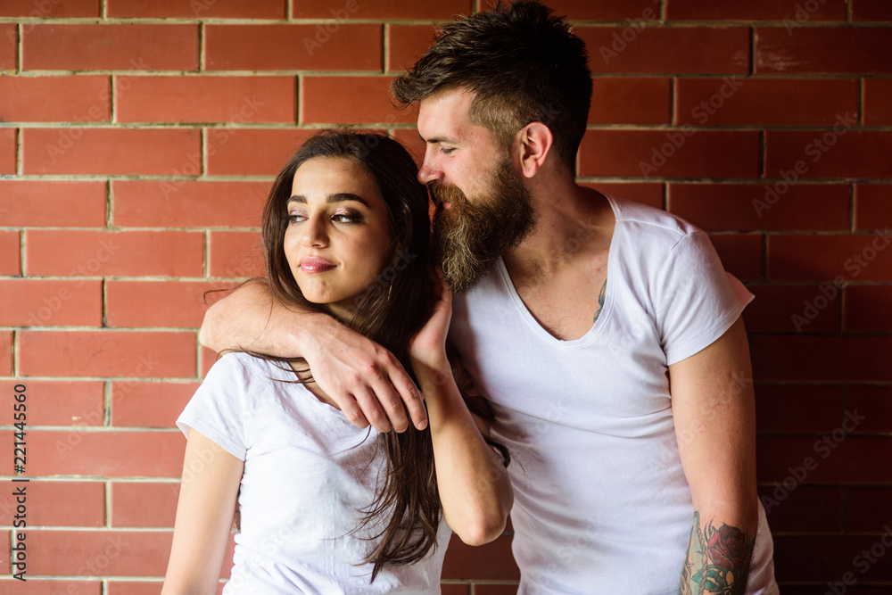 Moments of intimacy. Couple find place to be alone. Couple in love hugs brick wall background. Girl and hipster romantic date intimacy moment. Couple enjoy intimacy cuddling without witnesses
