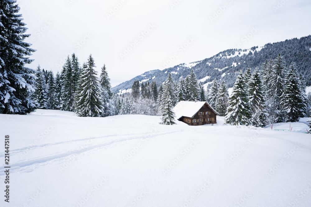 Old wooden house in romantic winter landscape