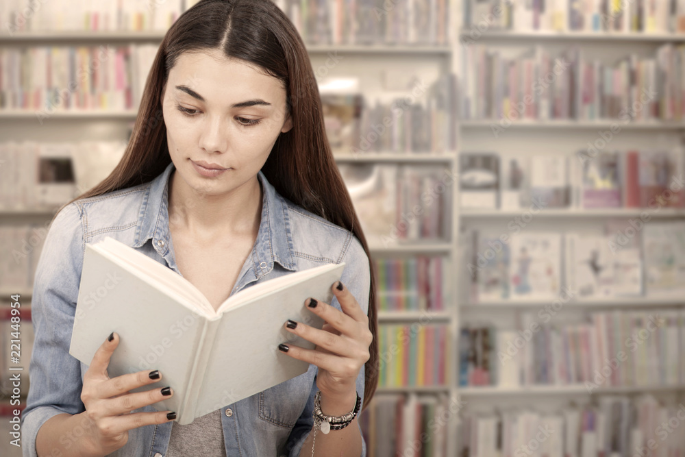 young woman reading book at library young woman reading book at library