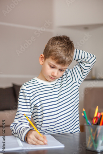 Portrait of a boy doing homework