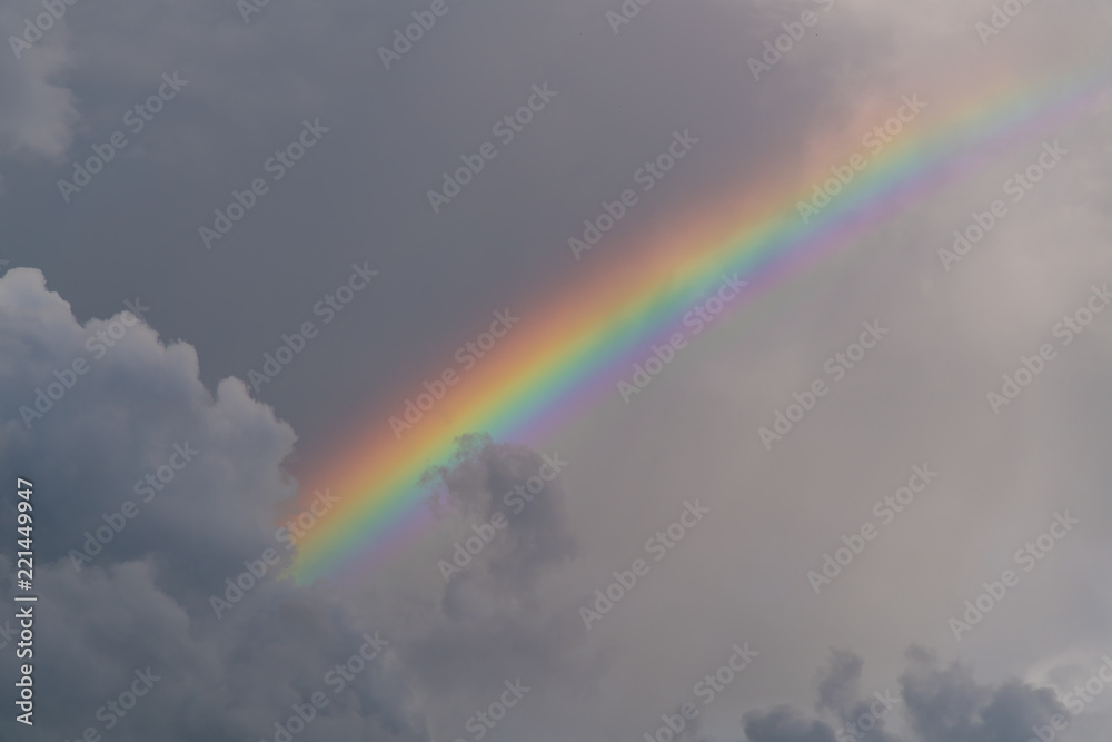 The rainy cloud with bright and colorful rainbow