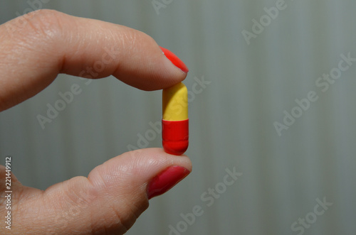 capsule for treatment, a beautiful capsule in the hands of a girl for losing weight