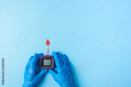 Nurse making a blood test with red blood drop with Blood glucose test strip and Glucose meter