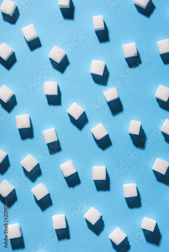 white sugar cubes isolated on blue background. Top view