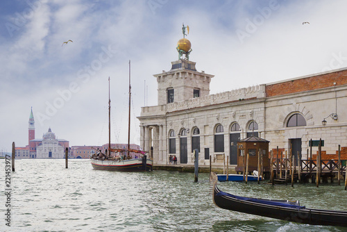 Venice, Italy, Punta della Dogana center for contemporary art. This is a former Venice customs building. On the tower you can see the sculptures of Atlases, supporting the ball