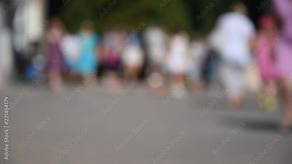 Unrecognizable people walking on the street, blurred background Unrecognizable people walking on the street, blurred background