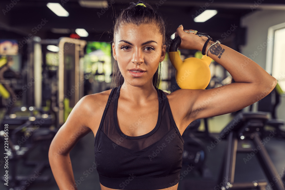 Fototapeta premium Fitness training with kettlebell in sport gym