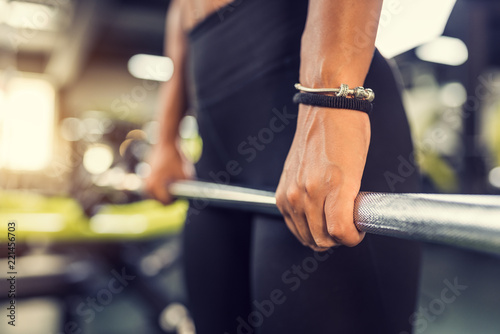 Woman pulling up large barbell in fitness class