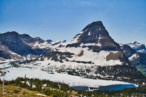 Hidden Lake in Glacier National Park with ice still on its surface in summer.