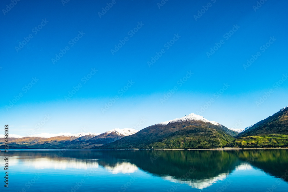 Stunning beautiful view beside lake Wanaka with alps mountain. Noon scenery with blue sky.