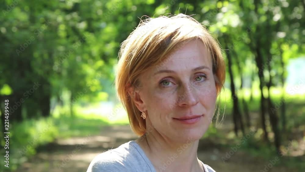 Beautiful woman posing in a summer park.
Beautiful woman posing in a summer park.