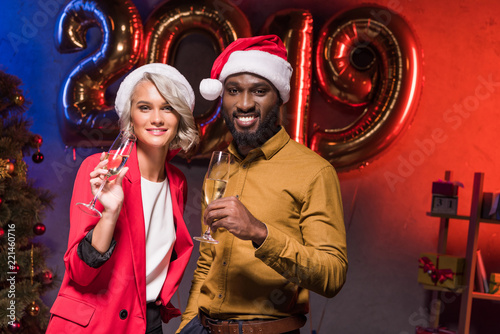 african american businessman and caucasian businesswoman at new year corporate party