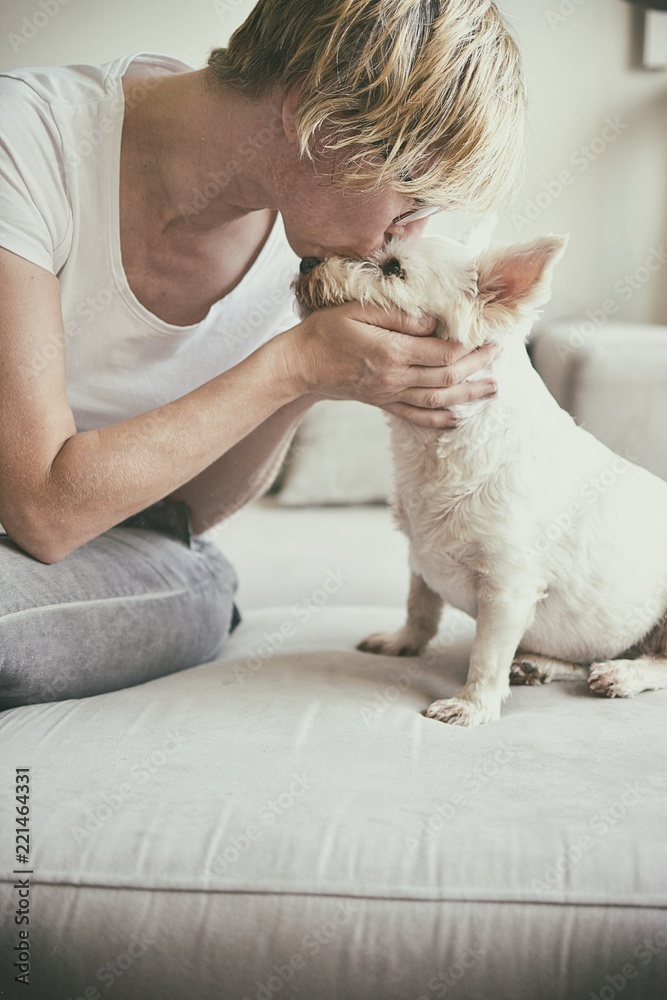 Old woman kissing a dog
