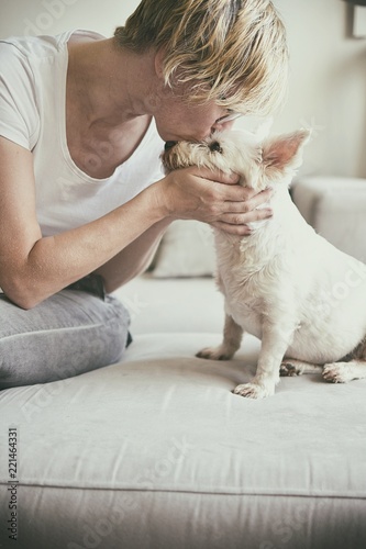 Old woman kissing a dog